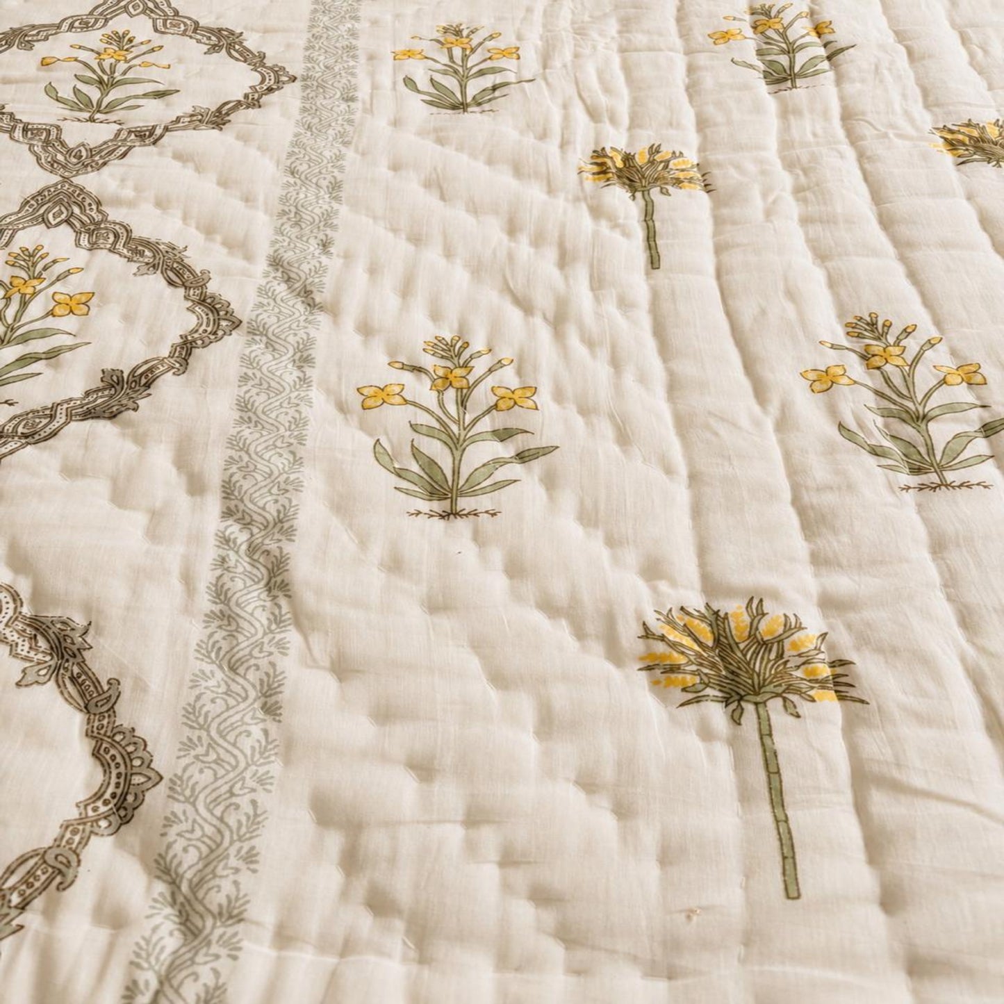 Close-up of a Jaipuri Block Print Razai featuring yellow flowers and decorative borders.