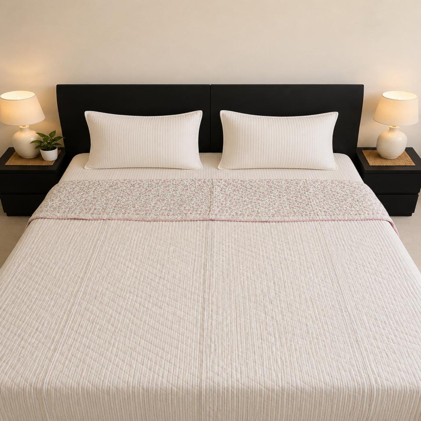 A neatly made bed with a beautiful stripes Jaipuri Razai, having a subtle pin stripes pattern, set against a dark brown headboard with bedside tables and lamps.