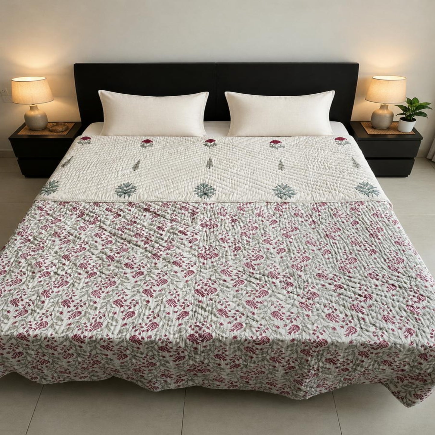 A beautiful floral pattern  and styled in a reversible layout, on a bed with two white pillows and a coffee brown headboard.
