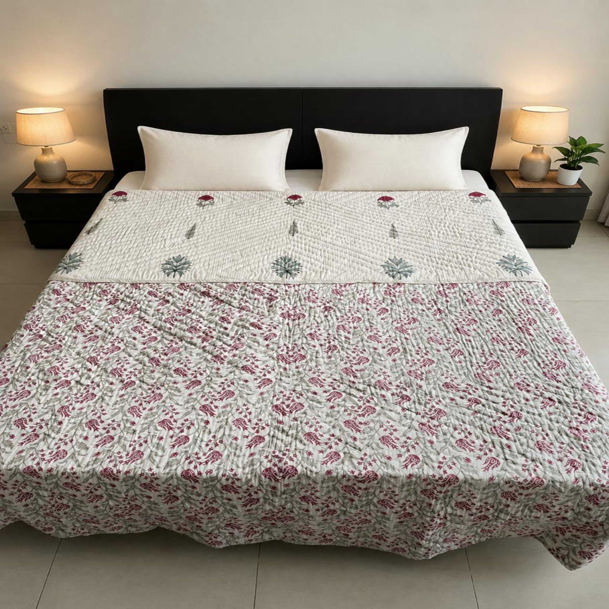 A beautiful floral pattern  and styled in a reversible layout, on a bed with two white pillows and a coffee brown headboard.